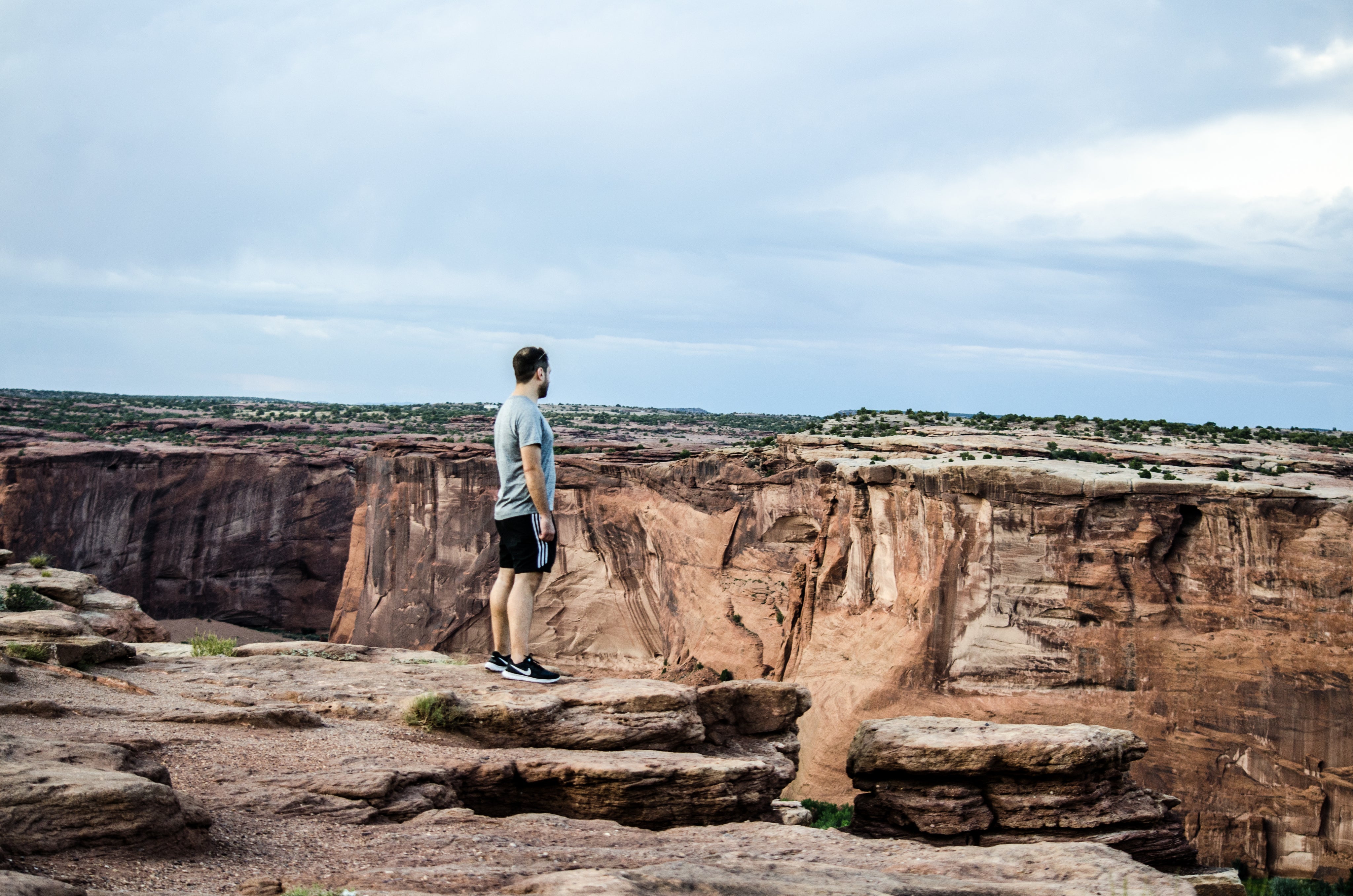 files/a-man-on-a-rocky-plateau-overlooks-a-deep-canyon.jpg